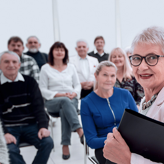 A group of senior citizens sits in a class