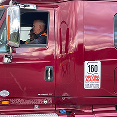 A man sitting in a tractor trailer