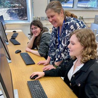 Students in the cybersecurity lab learn from the professor.